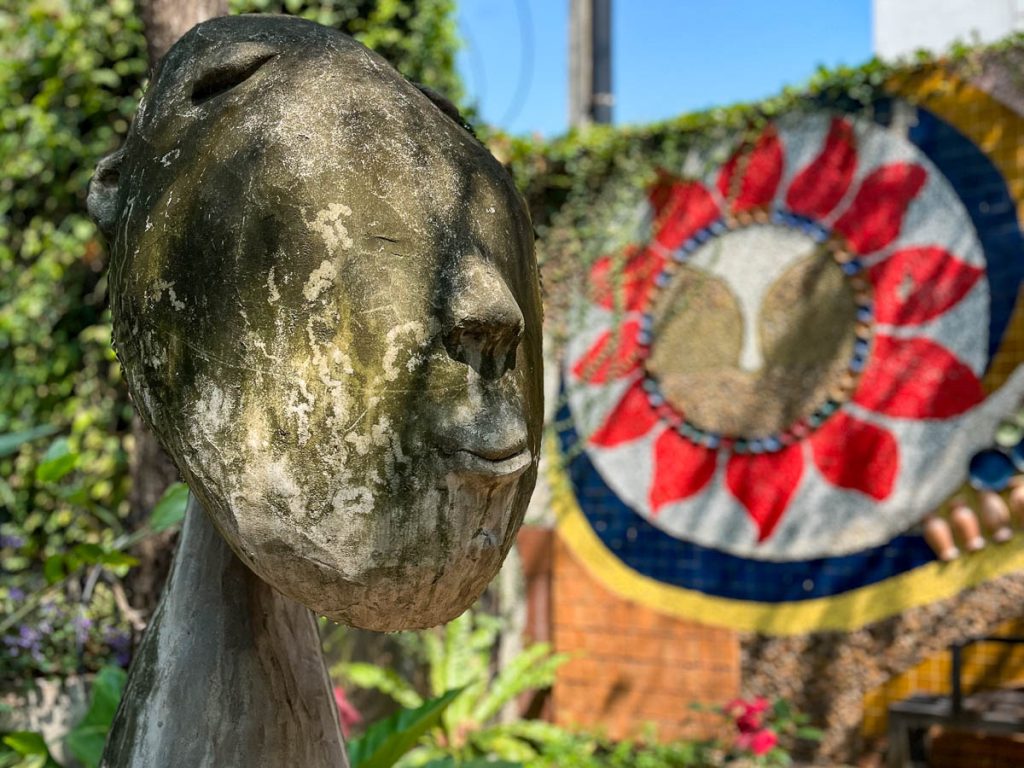 Sculptural garden art and mosaic wall in the outdoor garden at Caramellow Cafe Chiang Mai
