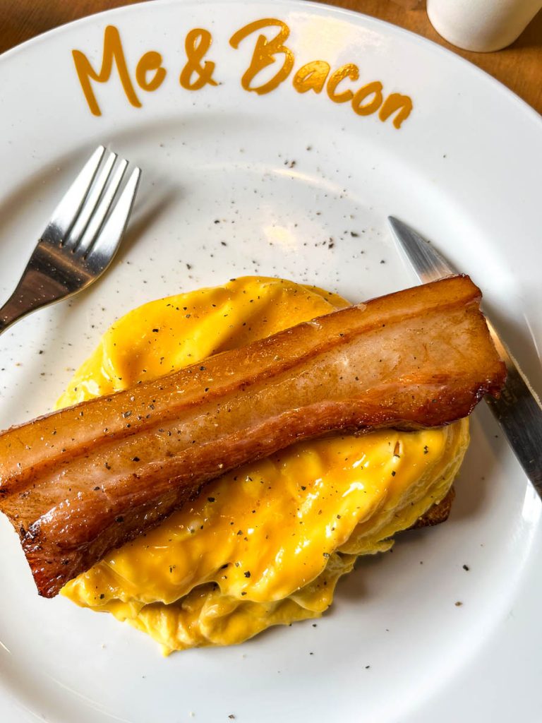 The ultimate brunch plate: thick-cut bacon, silky scrambled eggs, and housemade sourdough from Me&Bacon