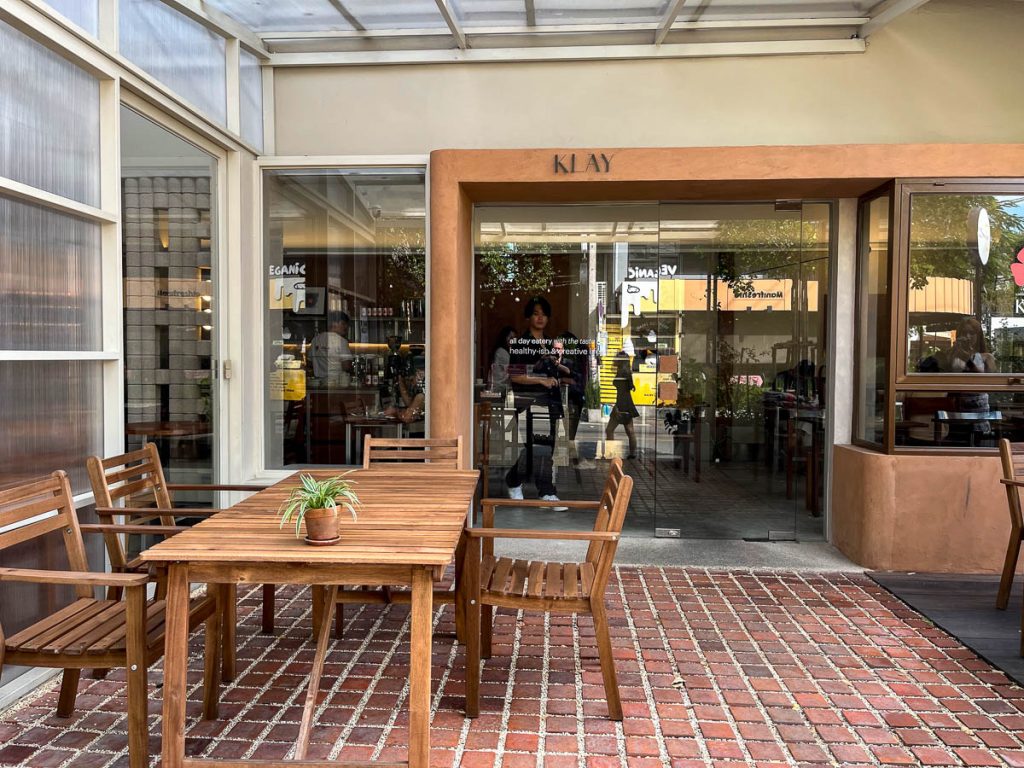 Rustic bricks and natural wood set the tone outside at KLAY, Chiang Mai
