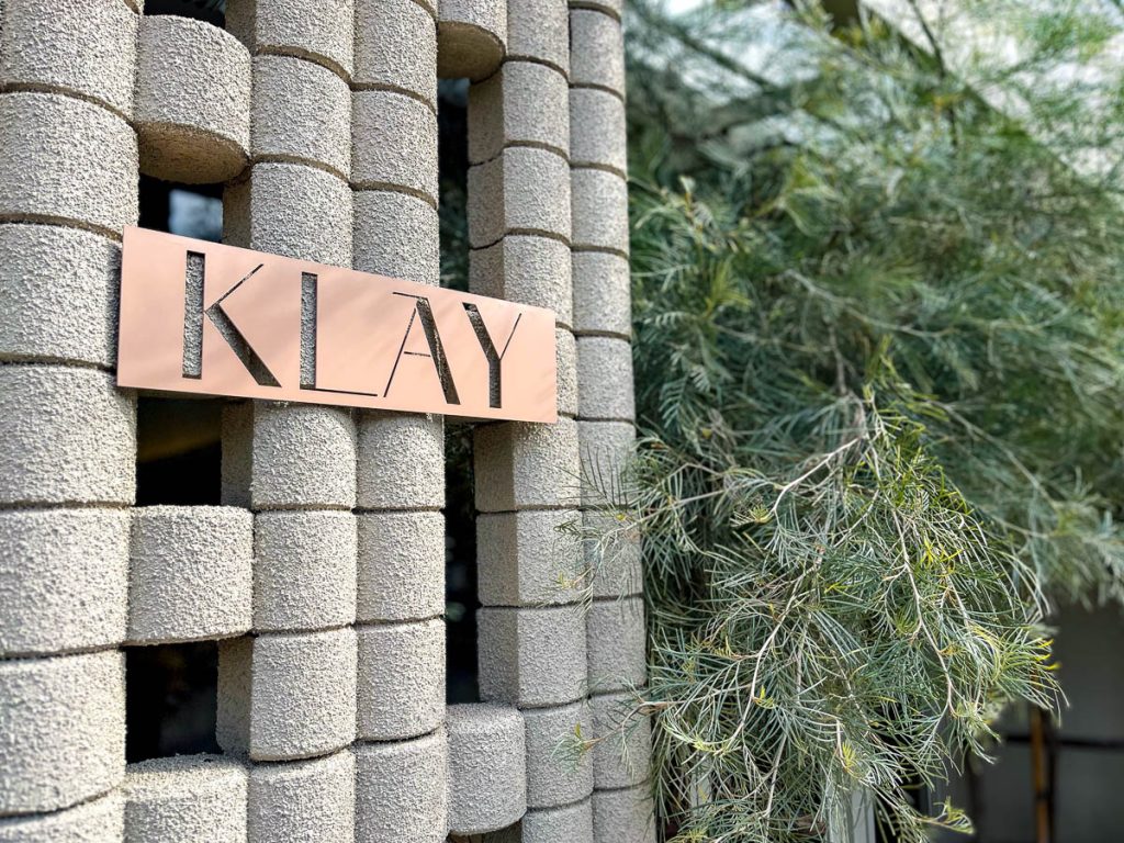 KLAY Cafe Chiang Mai curved brick facade with cylindrical textured blocks and signage