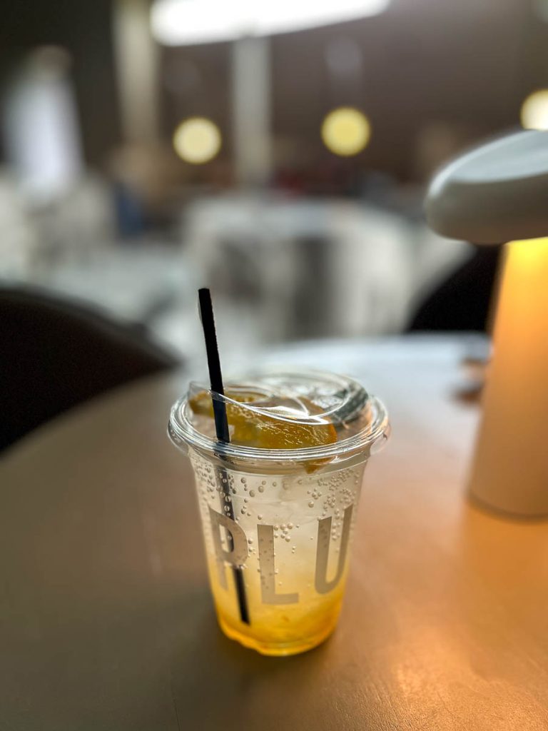 Bright, citrusy, and seriously refreshing—PLUTO’s Yuzu Soda with a slice of orange
