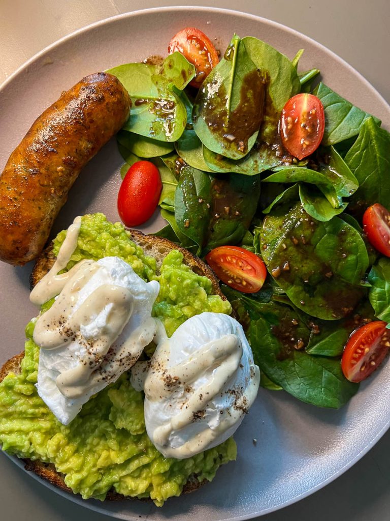 A cosmic brunch combo—Italian sausage and smashed avocado, grounded and delicious
