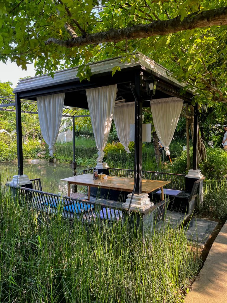 Pondside dining with a touch of theatre: shaded pavilions and glassy reflections set the scene at Fleur Cafe