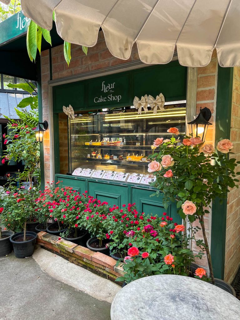 Fleur’s cake shop, framed by roses and vintage charm
