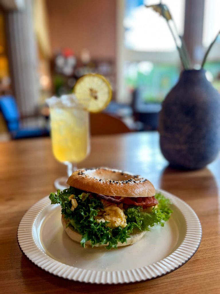 Breakfast comfort, the Haus 224 way — a bagel stacked with bacon and eggs