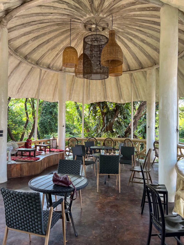 Open-air upper level of Much Room Cafe Chiang Mai with wicker seating floor cushions