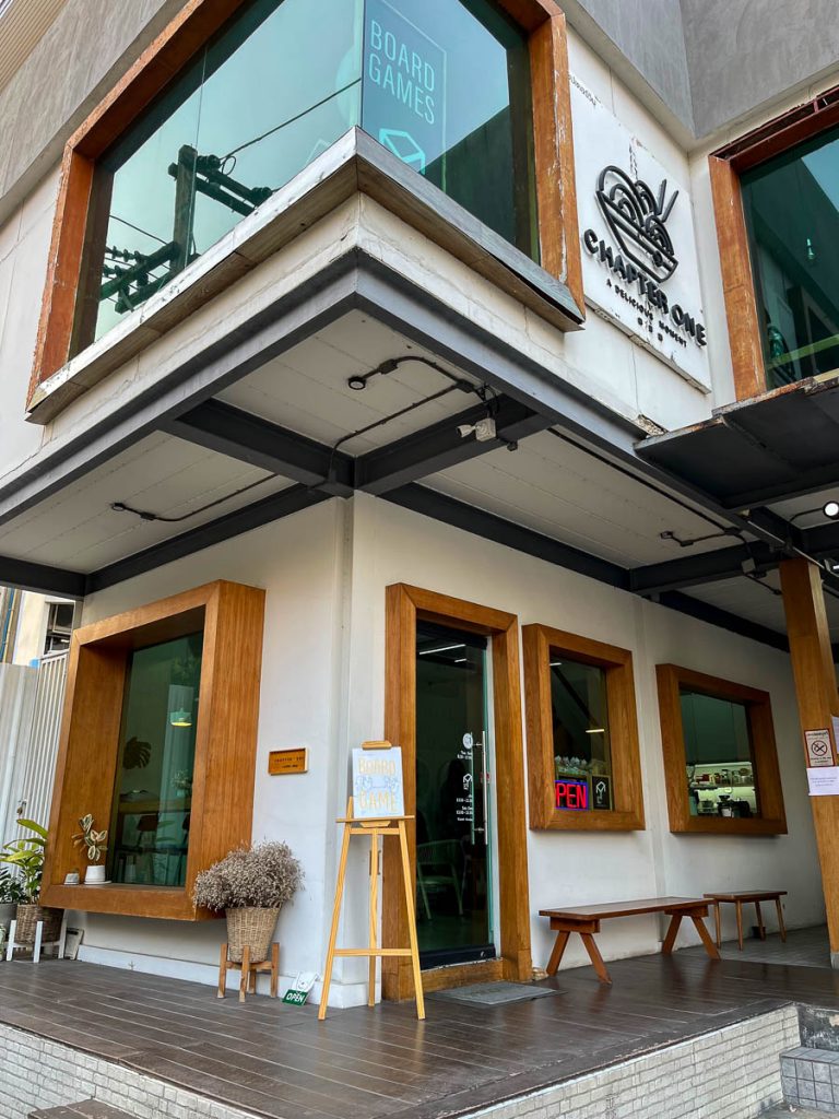 Chapter One cafe Chiang Mai exterior with wooden window frames, modern design and board-game signs