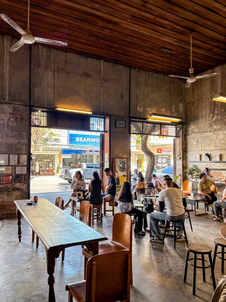 Open-front interior of Flo Coffee Brewers with communal tables in San Pa Khoi, Chiang Mai