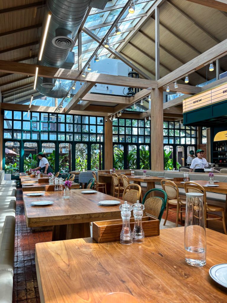 Fran’s Chiang Mai interior with high ceiling, skylight roof and wooden dining tables