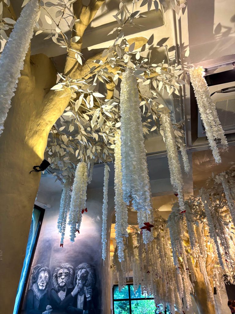 Whimsical interior design at Much Room Cafe in Chiang Mai with hanging floral décor