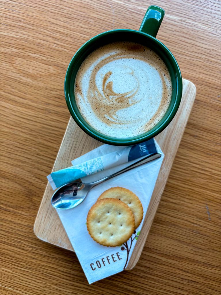 Espresso-based latte served with biscuits at Chapter One cafe Chiang Mai