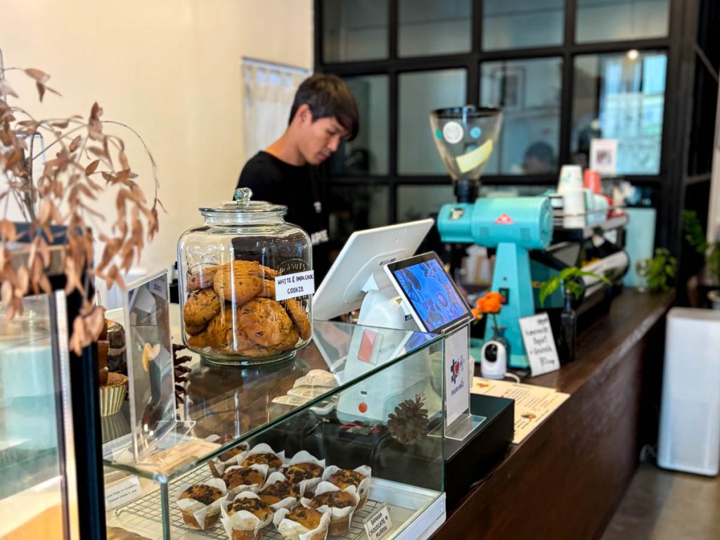 Coffee counter and cake display at Cottontree Coffee Roasters cafe in Chang Phueak, Chiang Mai