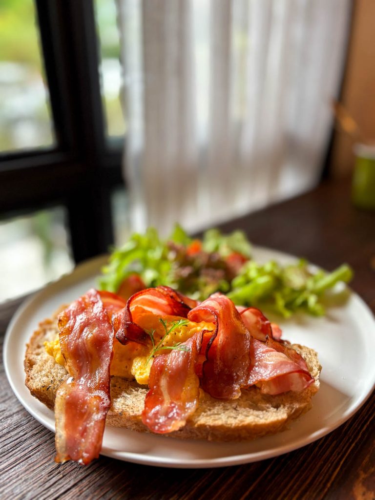 Scrambled eggs and bacon open sandwich on sourdough at Cottontree Coffee Roasters Chiang Mai