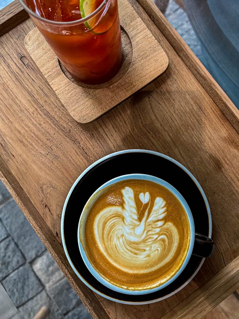 Latte with swan latte art and Thai iced tea on timber tray at Baristro Asian Style Chiang Mai
