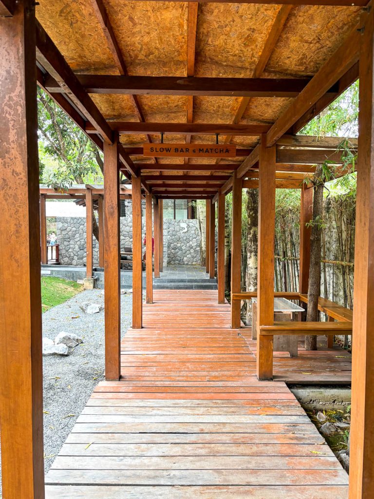 Covered timber walkway leading to Slow Bar and Matcha zone at Baristro Asian Style Chiang Mai