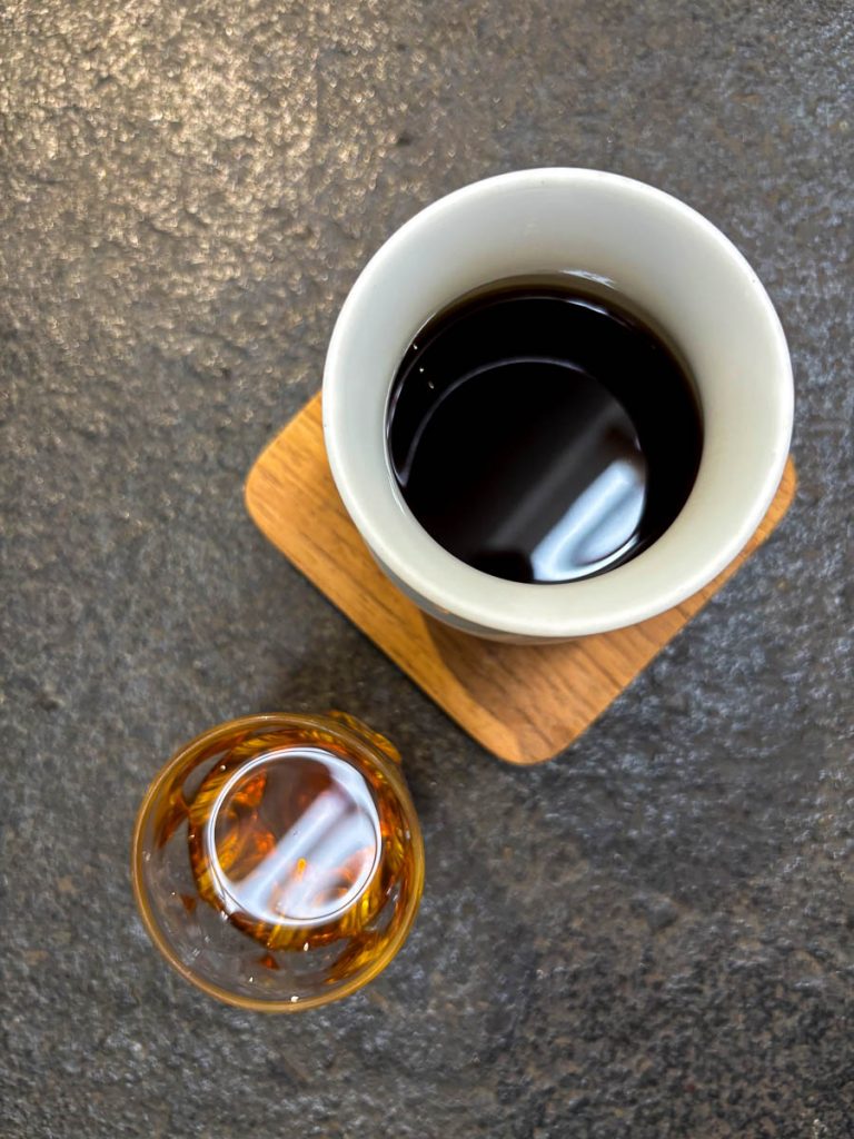 Pour over black coffee in white ceramic with palate cleanser at Baristro Asian Style slow bar Chiang Mai