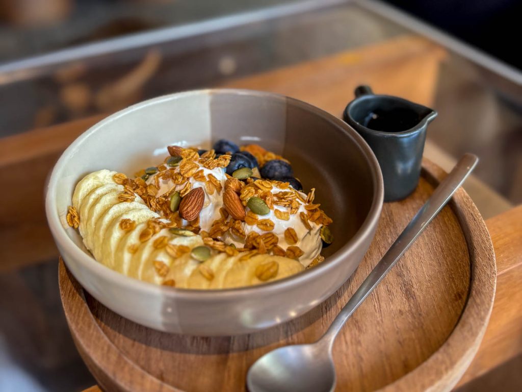 Greek yoghurt granola bowl with banana blueberries almonds and honey at Baristro Asian Style Chiang Mai