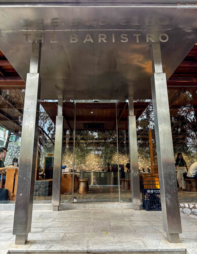 Architectural detail of steel entrance canopy and glass doors at Baristro Asian Style Chiang Mai