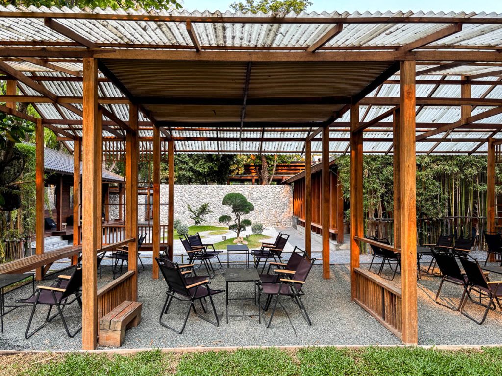 Garden zone with camping-style chairs at Baristro Asian Style Chiang Mai overlooking Japanese garden
