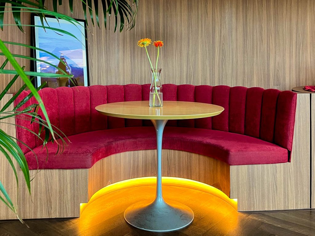 Elegant red velvet booth seating and stylish interior design at Haus 224 cafe in Chiang Mai, ideal for dates and special occasion dining