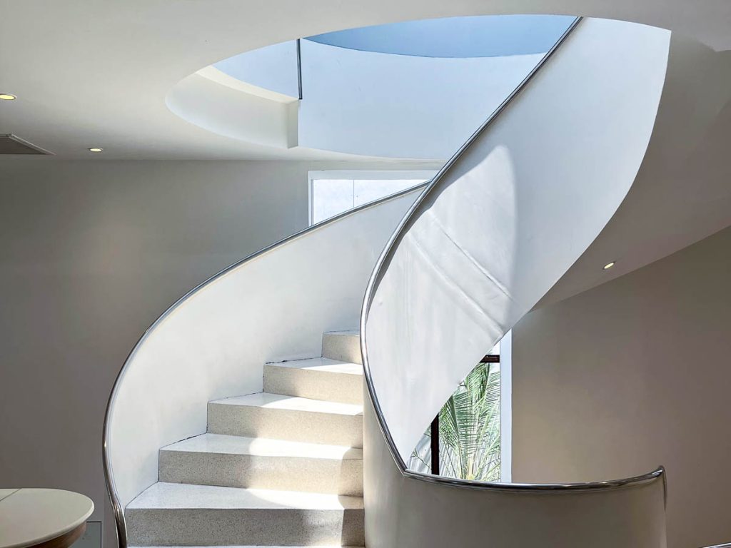 Morestto Chiang Mai white spiral staircase in modern cafe interior with natural light