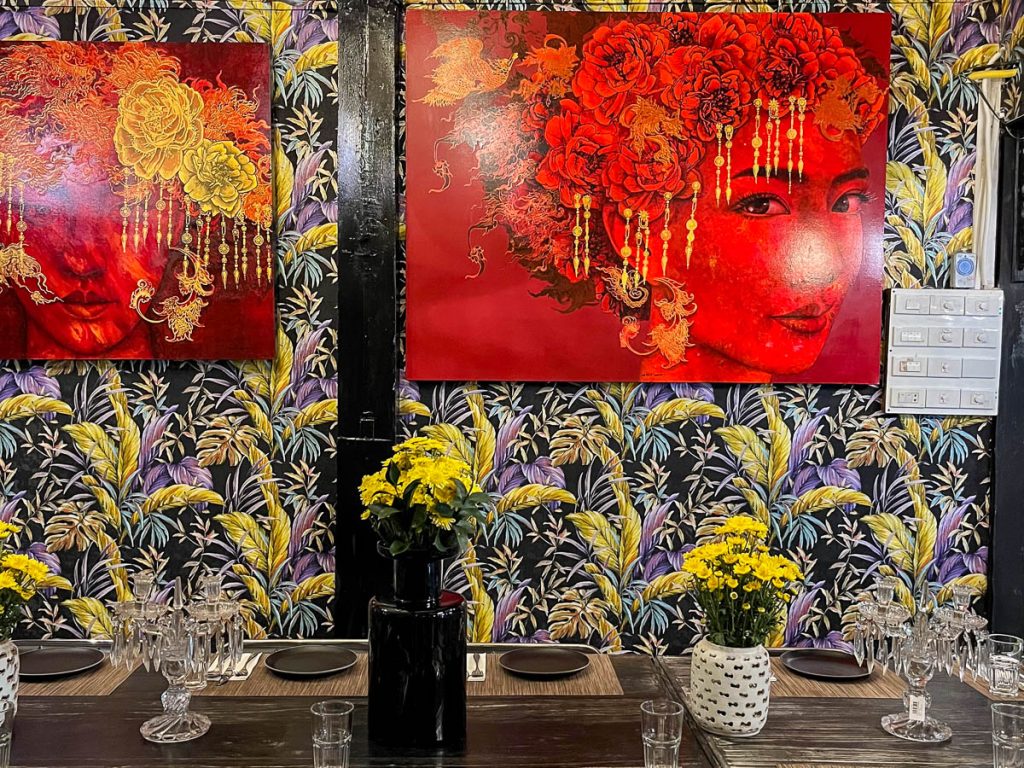 Colourful art-filled dining room at WOO Cafe, now PoonPoon, in Chiang Mai, ideal for romantic dinners and special occasions.