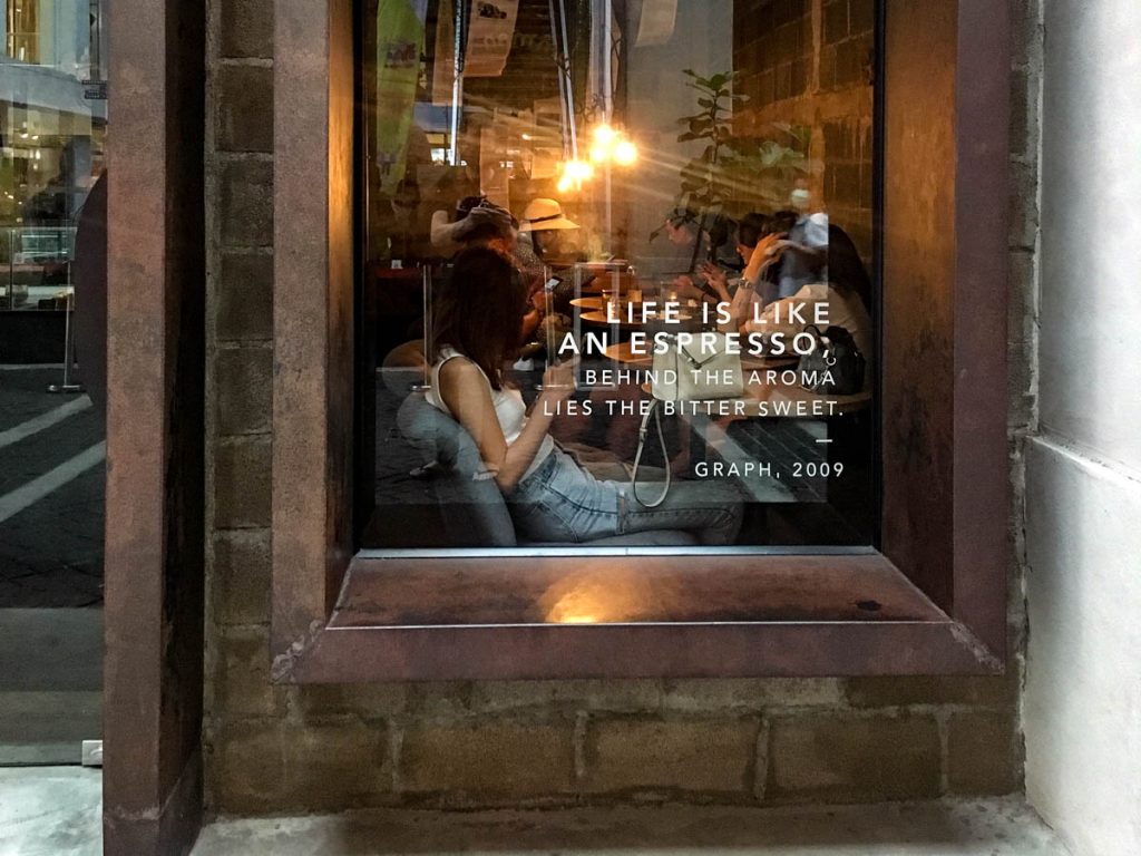 GRAPH One Nimman Chiang Mai window seating with warm interior lighting and cosy cafe atmosphere