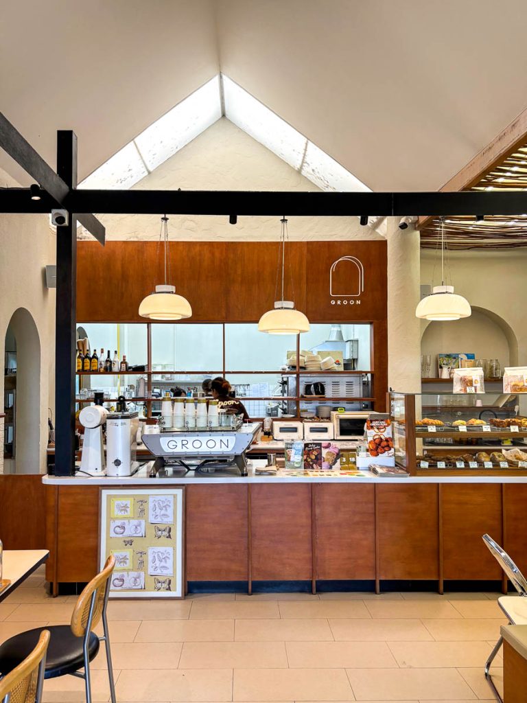 Coffee and bakery counter at GROON Bread & Brunch Cafe in Chiang Mai, framed by warm timber finishes and artisan bread displays