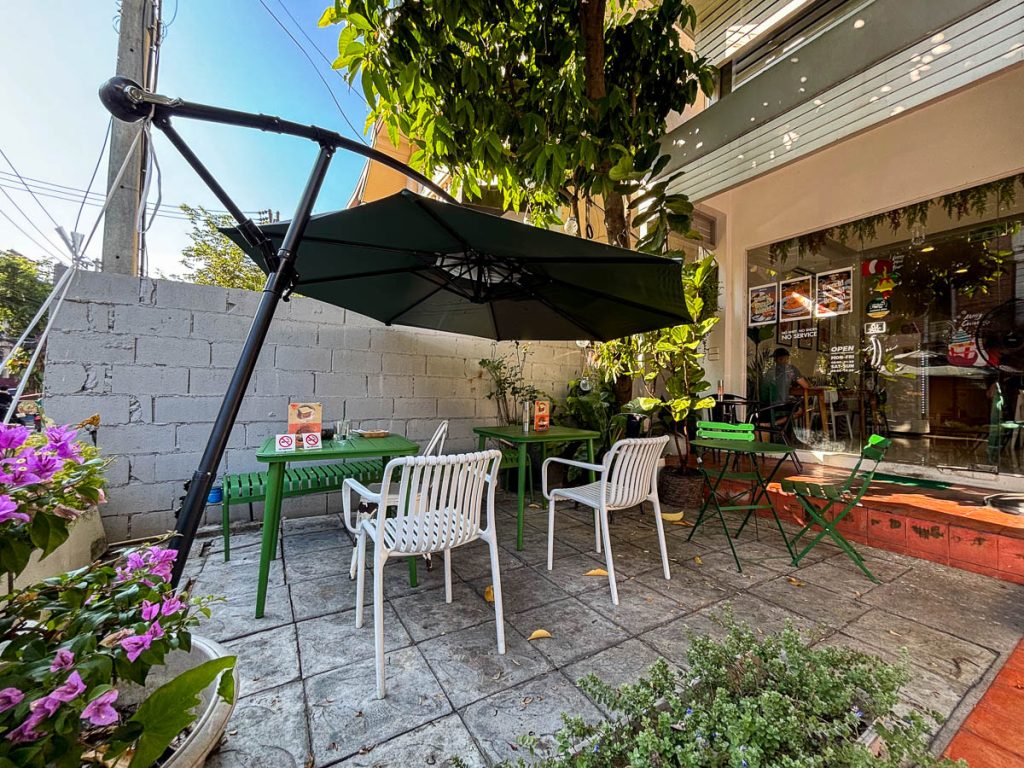 Healthy Junk Nimman exterior with shaded patio and casual outdoor dining area