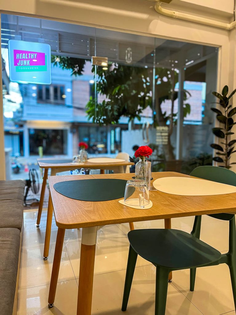 Healthy Junk cafe interior in Nimman with relaxed seating and neatly styled tables