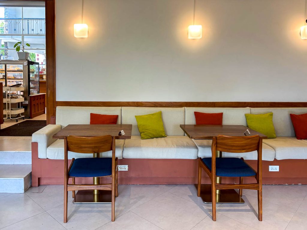 Bench seating and timber tables in the main dining area at Food4Thought East, Chiang Mai